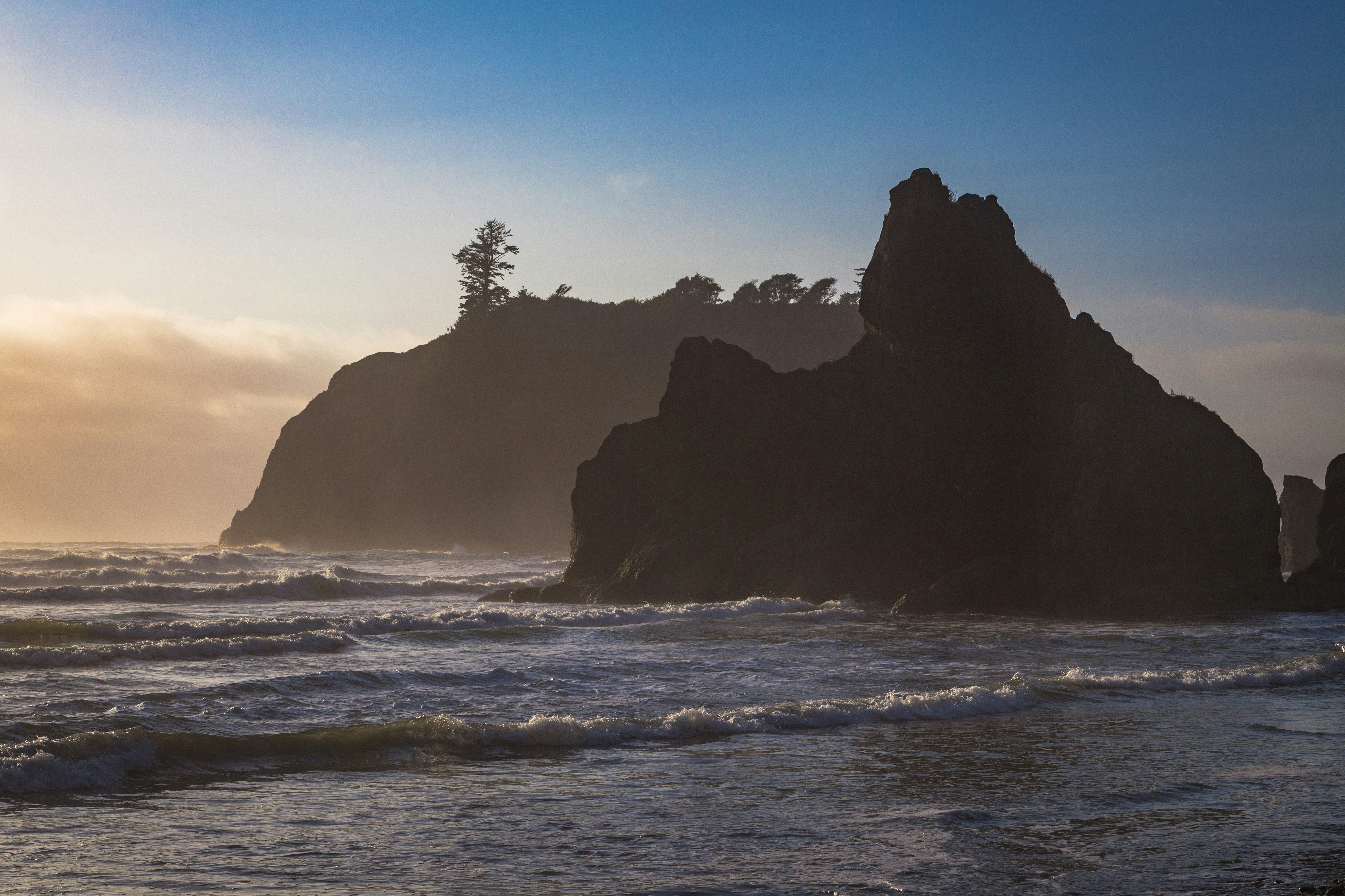 brown rock formation on sea during daytime